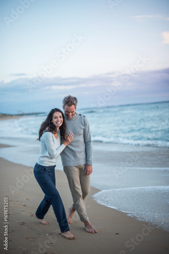  middle-aged couple walking on the beach