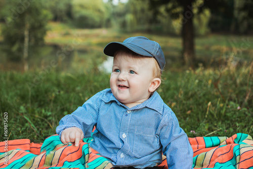Little adorable baby boy in a hat summer portrait