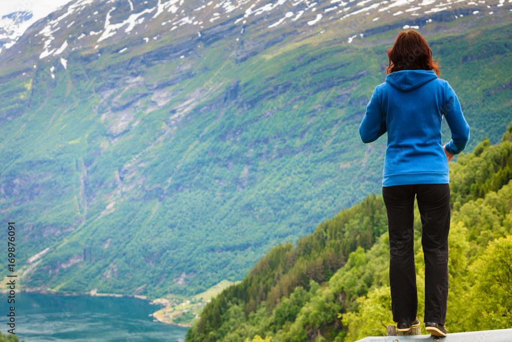 Woman tourist in norwegian mountains fjords