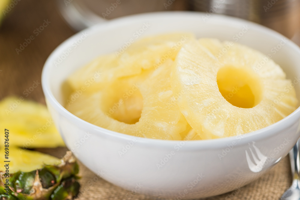 Wooden table with Preserved Pineapple Rings, selective focus Wooden table with Preserved Pineapple Rings, selective focus