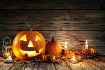 Halloween Pumpkins And Candles On Wooden