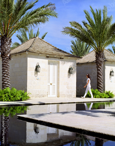 A spa attendant walks into a massage cabana called 