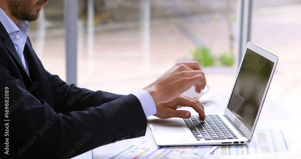 Tired businessman resting head on laptop at desk Tired businessman resting head on laptop at desk