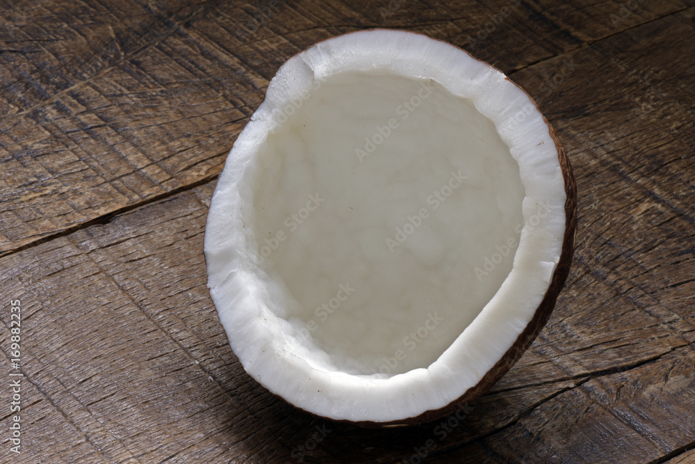 Broken coconut on table Broken coconut on table