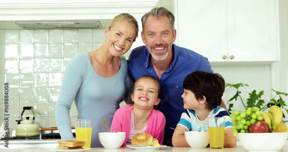 Portrait of smiling family standing in kitchen Portrait of smiling family standing in kitchen