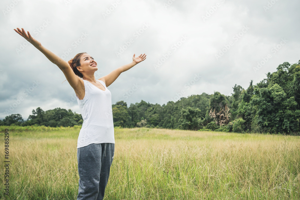 Asian women travel relax in the holiday. on a green pasture. Asian women travel relax in the holiday. on a green pasture.