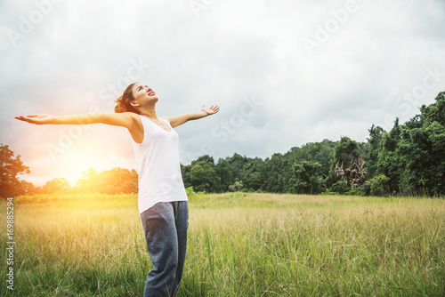 Asian women travel relax in the holiday. on a green pasture.