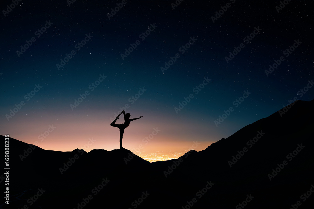 Man doing Yoga at night sky