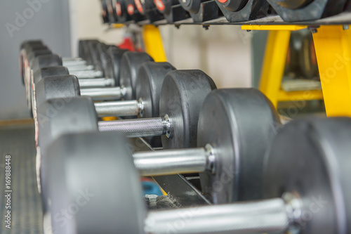Rows of dumbbells in the gym wait for those who will exercise to use,lifting dumbbell helps build many muscles, depending on the posture.