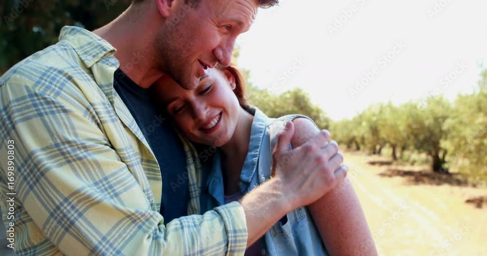 Happy couple interacting with each other in olive farm Happy couple interacting with each other in olive farm
