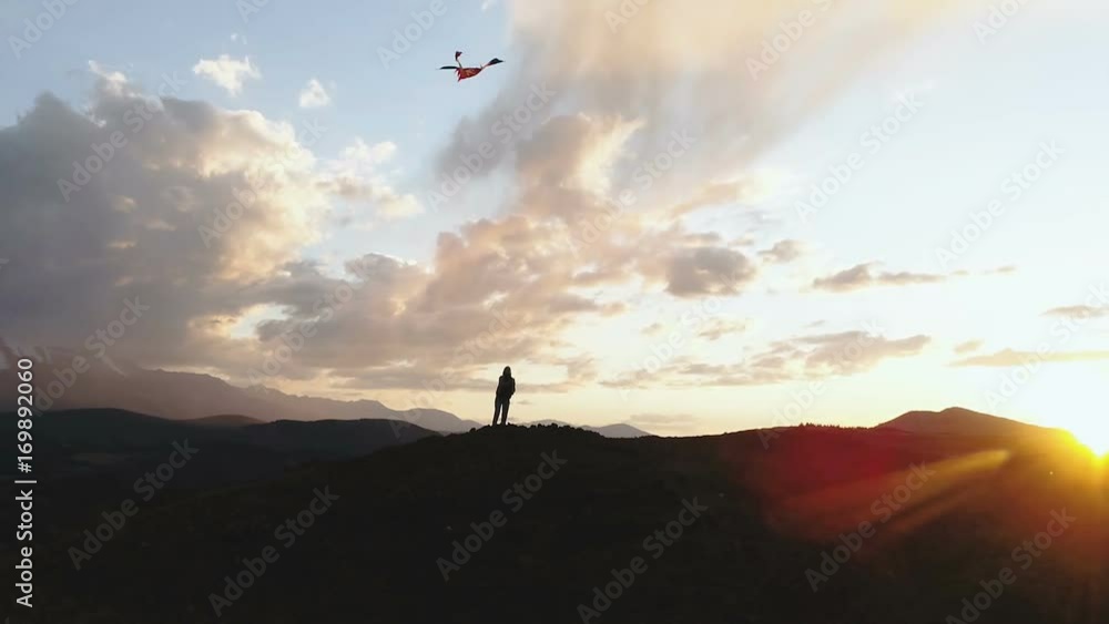 woman silhouette mountain golden sunset sky flying long tailed toy kite. 1080p slow motion woman silhouette mountain golden sunset sky flying long tailed toy kite. 1080p slow motion