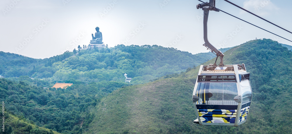 Obraz premium Tian Tan Buddha statue and cable car. Located at Ngong Ping, Lantau Island, in Hong Kong.