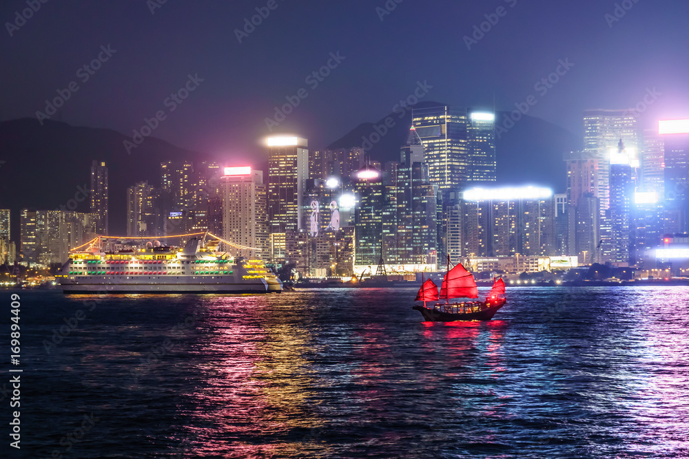 Fototapeta premium Sailing the antique boat DUKLING in Hong Kong. Enjoy skyscrapers and cityscape view across Victoria Harbour on an authentic Chinese junk.