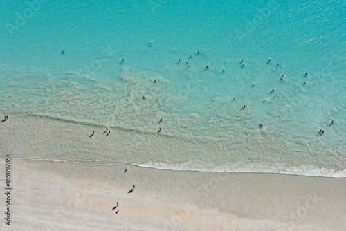 Looking down upon people enjoying the wide sands and waters of Cable Beach
