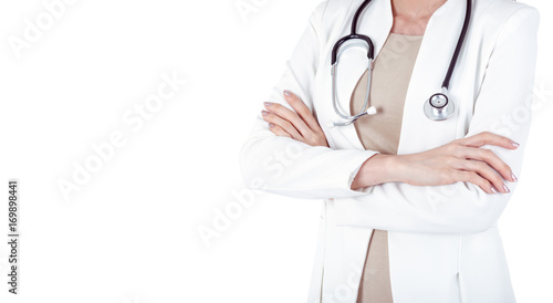 Closed up of an attractive Cheerful happy young medical doctor woman with stethoscope while crossed hands in white coat.Isolated on white