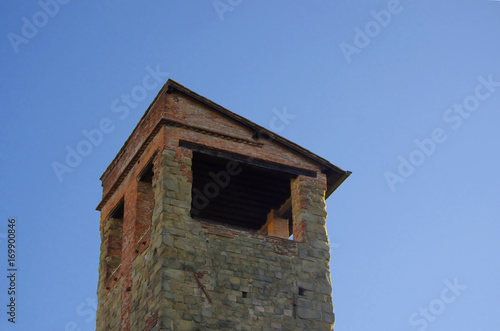 Ancient Italian stone tower and brick