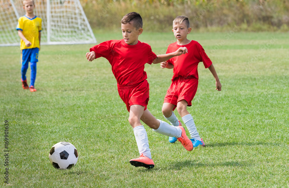Kids soccer football - children players match on soccer field Kids soccer football - children players match on soccer field