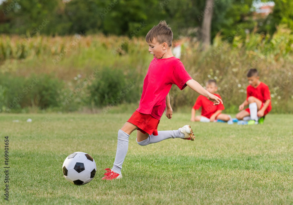 Kids soccer football - children players match on soccer field Kids soccer football - children players match on soccer field