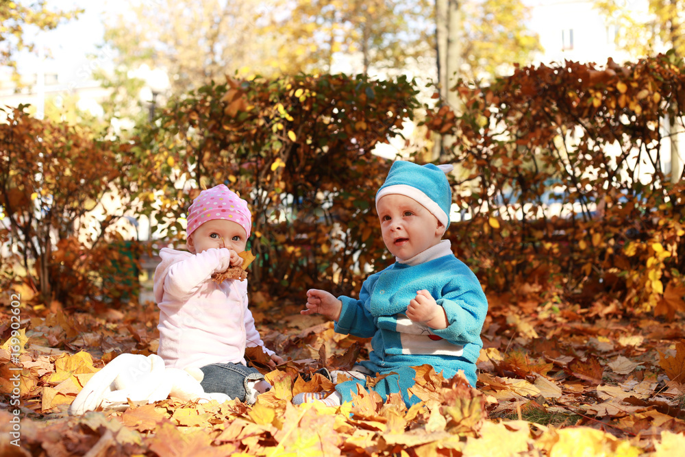 Two Little child in nature sitting in open suitcase. Two Little child in nature sitting in open suitcase.