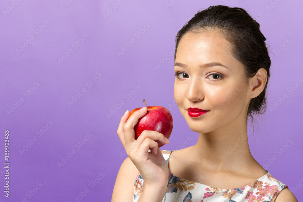 Smiling woman holding red apple Smiling woman holding red apple