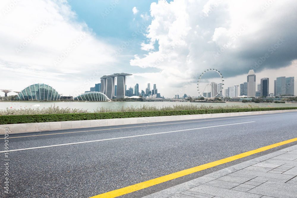 empty asphalt road with cityscape of singapore