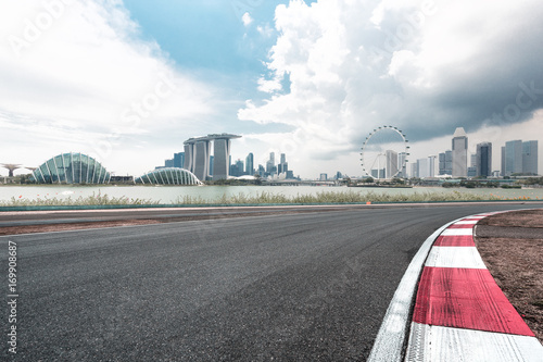 empty asphalt road with cityscape of singapore © zhu difeng