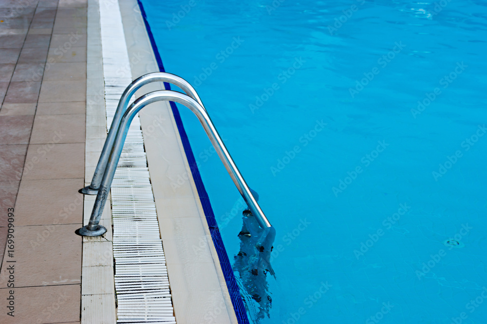 blue swimming pool with steel ladder