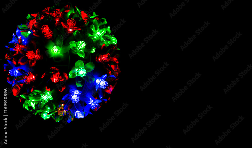Red, blue and green light on dark background for Christmas concept with copy space