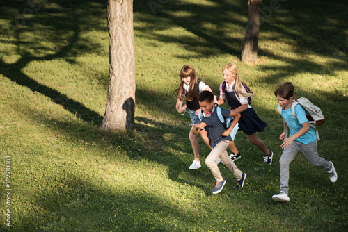 multiethnic teenagers running in park © LIGHTFIELD STUDIOS