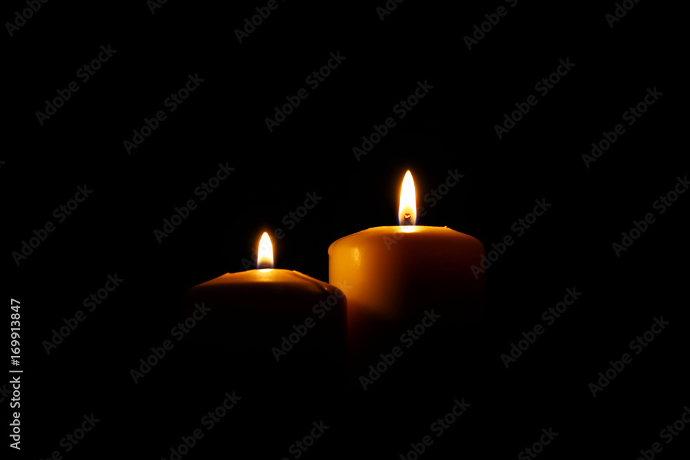 Burning candles over black background with bokeh lights Burning candles over black background with bokeh lights