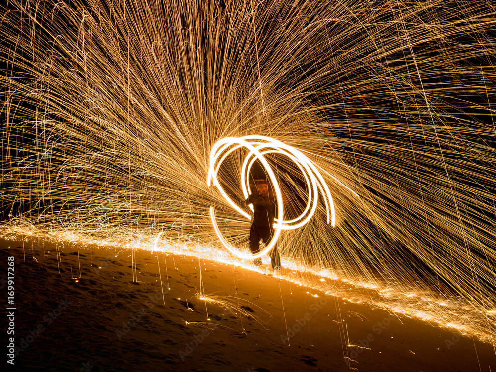Obraz premium Amazing boy Fire Show at night on beach