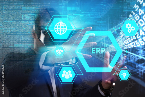 Business, Technology, Internet and network concept. Young businessman working in virtual reality glasses sees the inscription: ERP