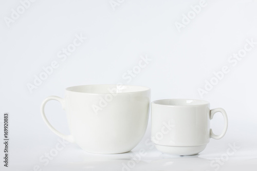 Two white porcelain mugs, different size and design, clean dishes mock up