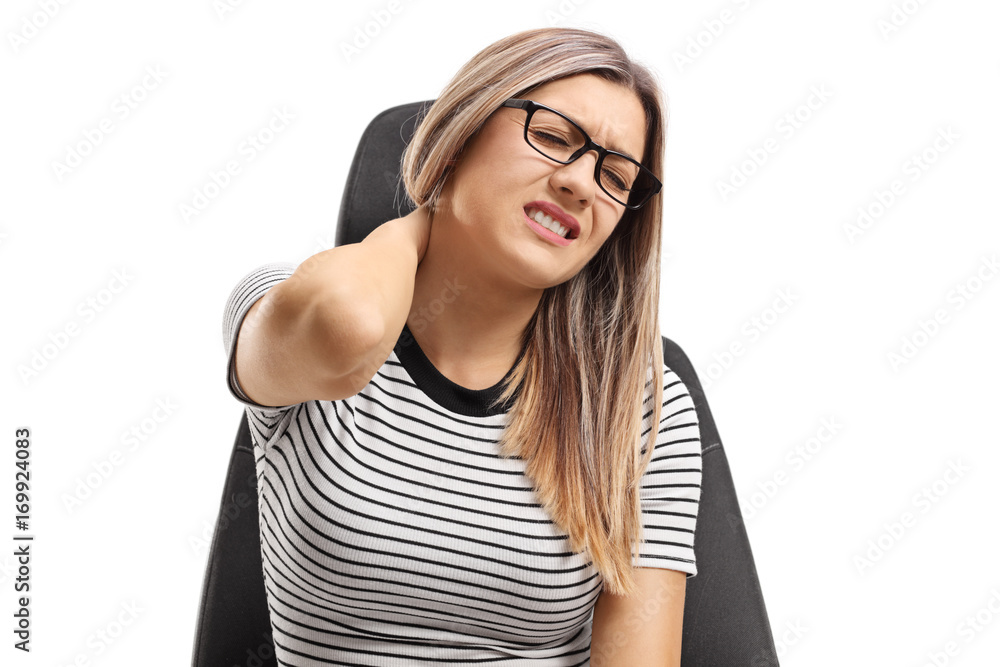 Young woman seated on a seat experiencing neck pain Young woman seated on a seat experiencing neck pain