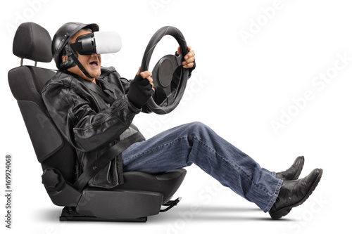 Elderly biker sitting in car seat and using VR headset
