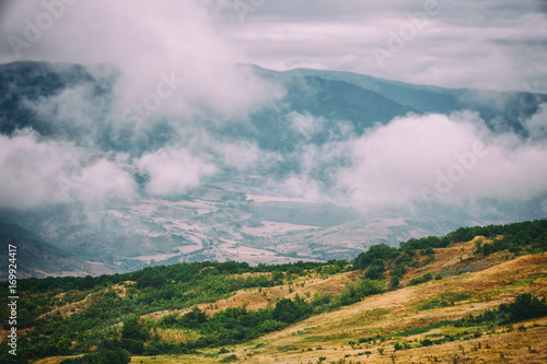 View of mountains Babadag in the clouds and a river Girdimanchay Lahij yolu from the side in Lahic village, Azerbaijan photo