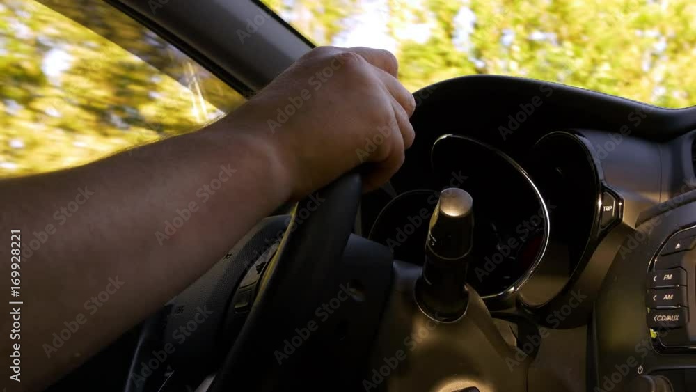 Man Hands On Steering Wheel Driving In Sunny Day Man Hands On Steering Wheel Driving In Sunny Day