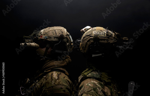 Two soldiers in military uniform on background of dark wall 17 photo
