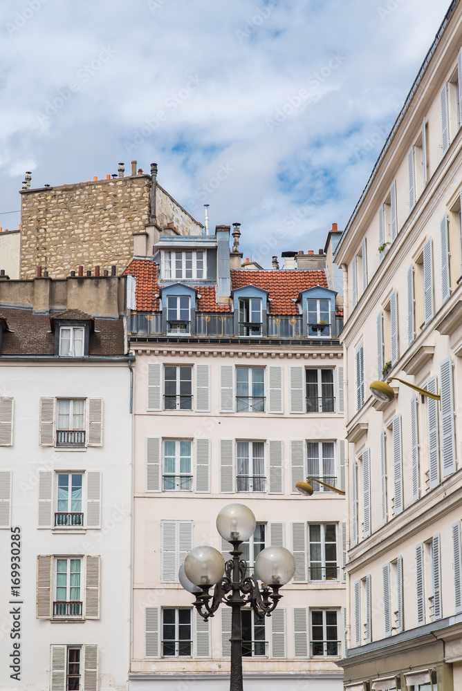Fototapeta premium Paris, attractive facades in Saint-Germain-des-Pres, with geometry of the windows, charming typical building 