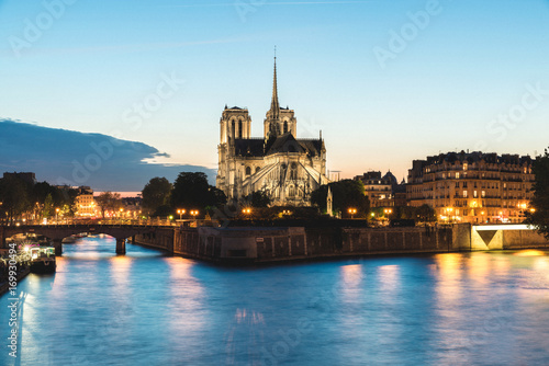 Notre dame de paris cathedral with Seine river at night in Paris  France.