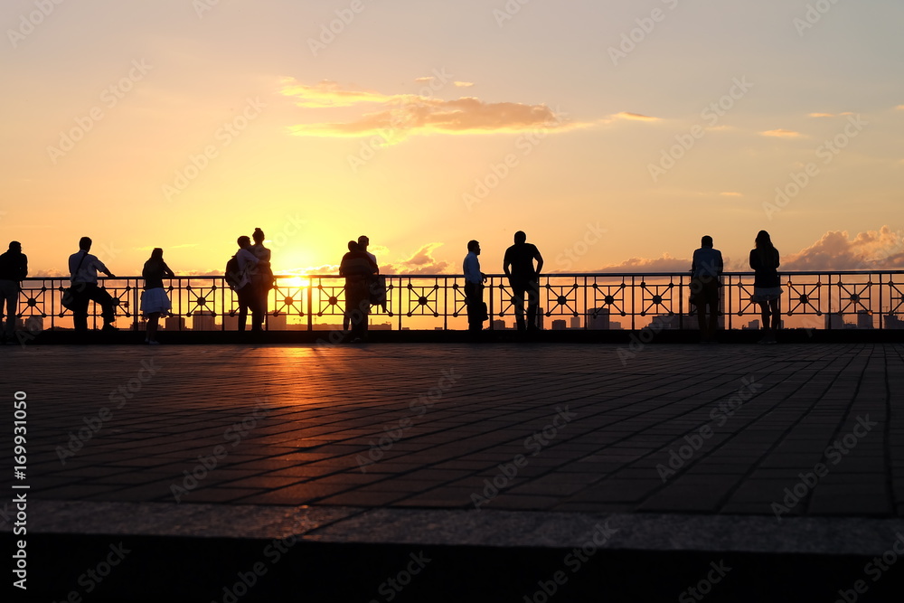 People's silhouettes at sunset
