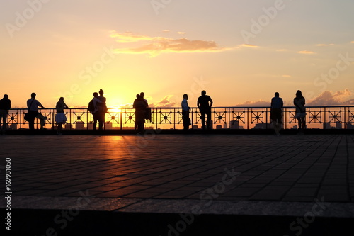 People's silhouettes at sunset