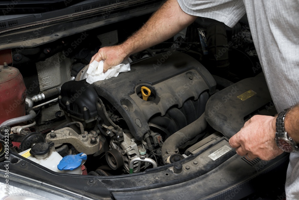 The mechanic fixes the vehicle's engine The mechanic fixes the vehicle's engine
