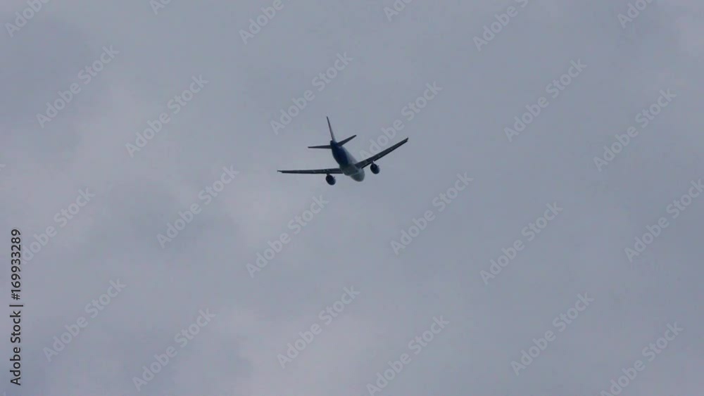Plane flies in a cloudy sky. A passenger plane on the way down. Plane flies in a cloudy sky. A passenger plane on the way down.