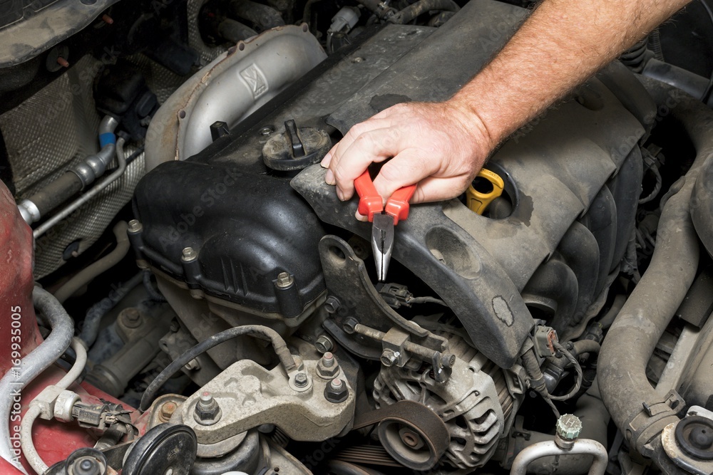 The mechanic fixes the vehicle's engine The mechanic fixes the vehicle's engine