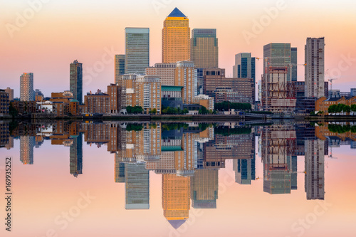 Pink sunset at Canary Wharf and its reflection from river Thames in London
