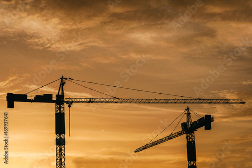 Tower crane on a construction site at sunrise