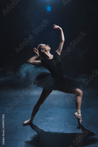 Fototapeta Naklejka Na Ścianę i Meble -  ballerina dancing in black tutu
