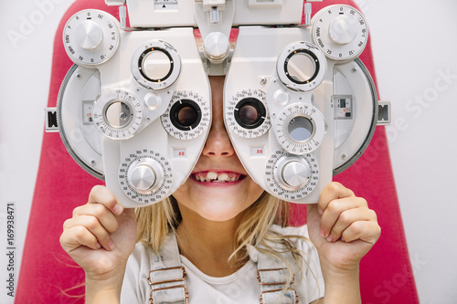 Fototapeta Naklejka Na Ścianę i Meble -  concept vision testing. child girl with eyeglasses