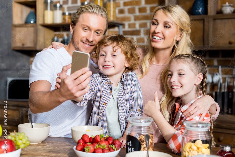 family taking selfie during breakfast